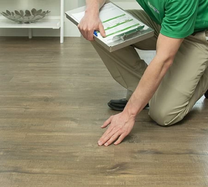 technician inspecting wood flooring